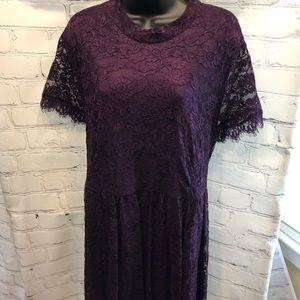Women’s tea length lace dress with open back.
